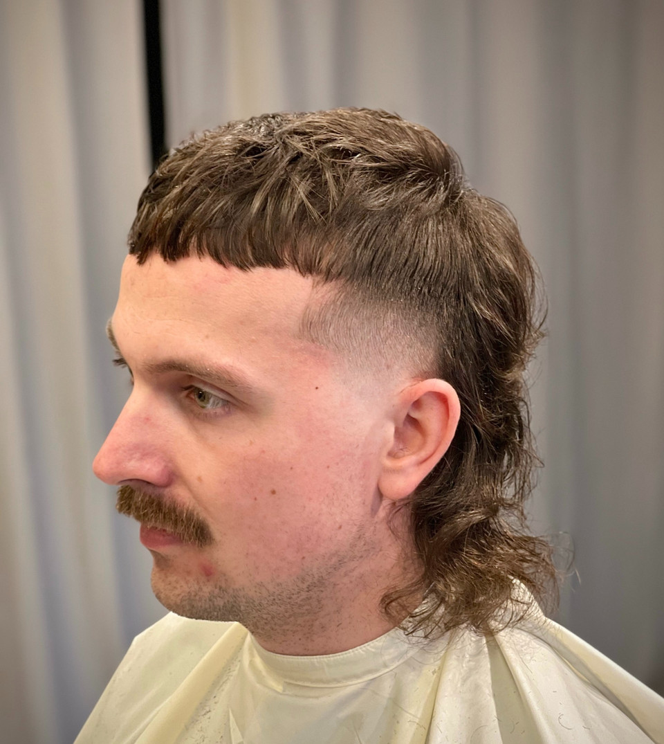 Long mullet haircut with fade on the sides-